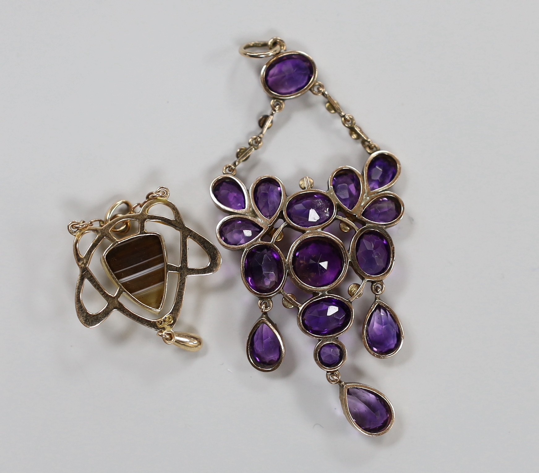 An early 20th century Art Nouveau 9ct and band agate set drop pendant, 37mm and a similar amethyst and seed pearl cluster set pendant, 62mm.